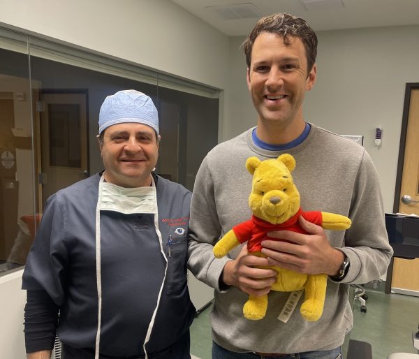 Happy LASIK patient posing with Dr. George Joseph, M.D