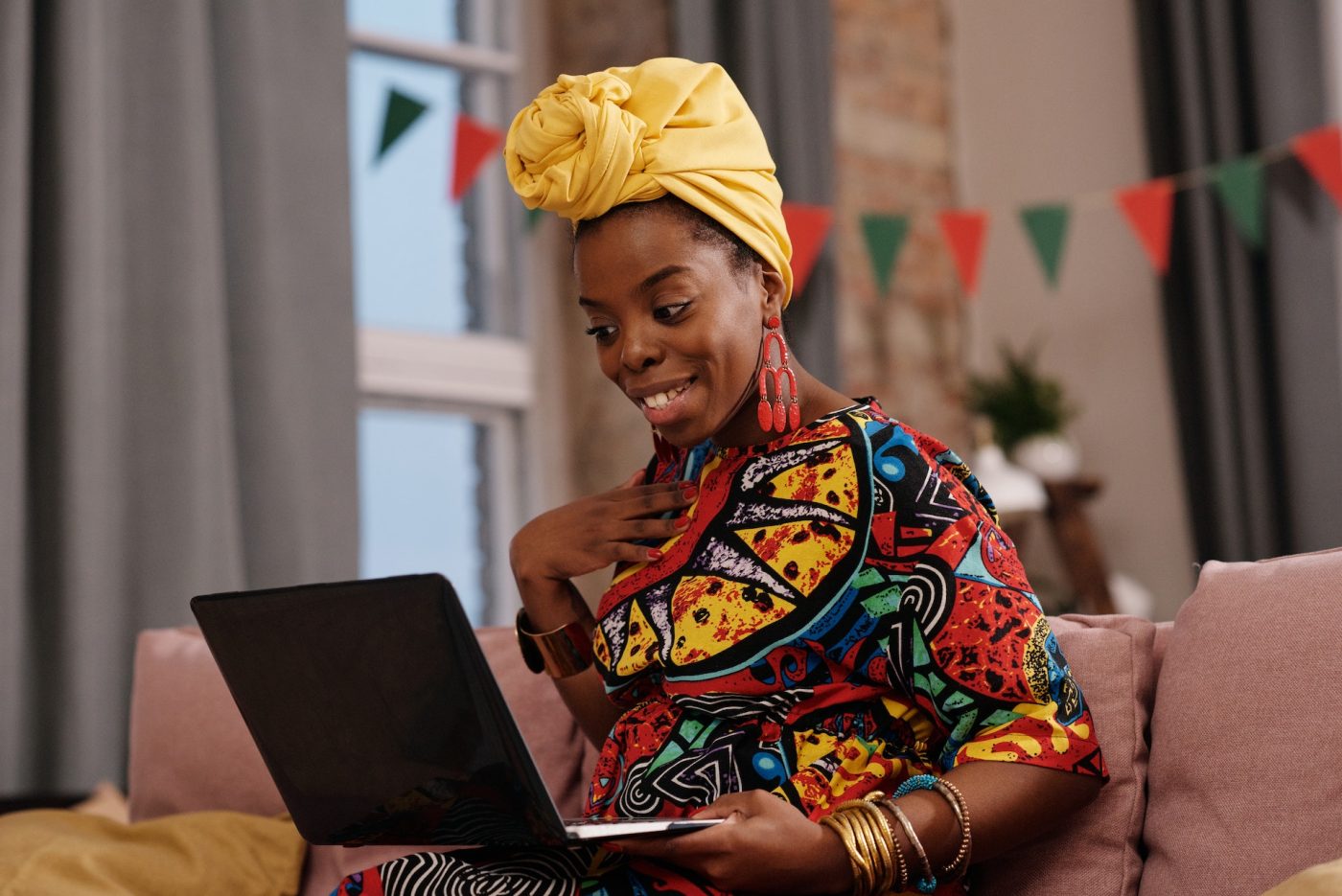 millennial woman wearing a colorful dress with a bright yellow headwrap