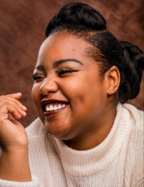 woman of color smiling and happy that she enhanced her vision after LASIK