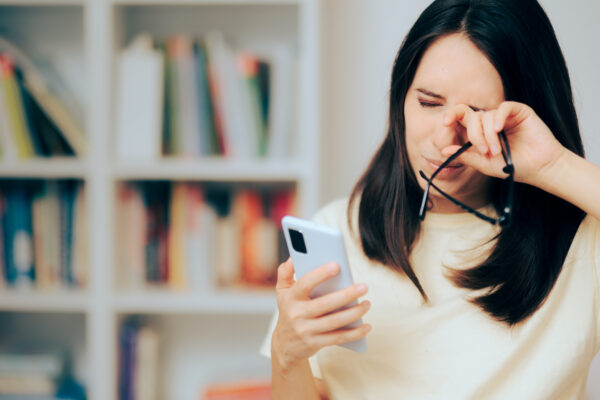 woman rubbing her eye because of constant eye twitching